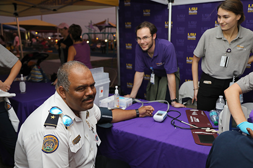 LSU Health checking blood pressure at Night Out Against Crime